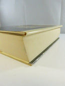 Close view of the upper spine and head of the Roots dust jacket, showing chipping and wear.