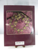 Rear jacket cover of Estate Jewelry 1760-1960 showing a gold-tone necklace on patterned fabric and the ISBN barcode.