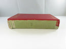 Low side view of the red cloth Torchy hardcover, showing gilt spine lettering and a worn loose dust-jacket fragment beneath.