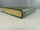 Angled view of the hardcover’s dust-jacket spine and tanned page edges, showing wear at the jacket edges.