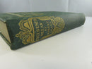 Close view of the green cloth spine with gilt Unleavened Bread and Robert Grant lettering and floral decoration
