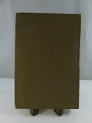 Close side view of the worn cloth spine, showing faded gilt lettering and cloth loss at the head.