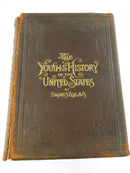 Front cover of a leather volume of The Youths' History of the United States by Edward S. Ellis, showing gilt title and damaged spine edge.