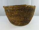 Side view of the tapered coil basket showing frayed fibers along the upper rim.