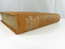 Close view of the aged, toned fore-edge and worn brown cloth binding of the hardcover.
