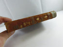 Worn leather spine of Prince Otto with partially legible gilt title lettering and gilt floral decorations.