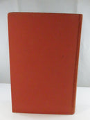 Rear red cloth cover of the hardcover, showing fading and light surface wear.