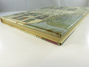 Angled side view of the hardcover in its dust jacket, showing the spine area, page edges, and jacket wear.