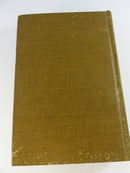 Plain olive cloth rear cover of The Law of the Land with surface rubbing and edge wear.