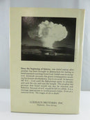 Angled view of the hardcover’s lower text block and brown spine ends, showing page-edge tanning and light spotting.