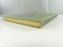 Low view of the upper spine and page edges of Introduction to Dynamic Meteorology, showing toned page edges and cloth wear.