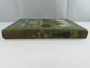 View of the faded green cloth spine with decorative floral illustration and rubbed ends