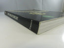 Angled view of the spine reading 7000 Years of Jewelry and Firefly, with worn cover corners and page edges.