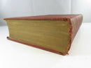 Bottom page edges and worn red cloth spine area of one volume, showing fraying and exposed binding wear.