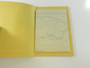 Opened yellow cardstock sleeve holding the folded multi-panel Montreal road map.