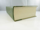 View of a matching green textured hardcover board with gilt geometric and floral decoration.