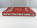 Spine view of The Third Season hardcover in its red GoldenIsle dust jacket, lettered with Jack P. Jones and the title.