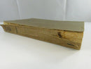 Low view of the book showing the badly detached and torn spine covering.