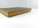 View of the bottom text block and lower board edges, showing age-toned page edges and cloth wear.