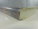 Top edge and dust jacket corner view of the book