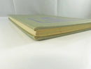 Plain pale green cloth back cover of the hardcover.