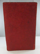 Bottom edge of the hardcover showing gilt page edges with age toning and wear to the cloth corners.