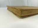 Close view of the page block and chipped, worn lower board edge.