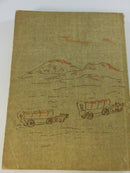 Low-angle spine view showing the worn spine lettered with Edwin G. Warman and the book title.