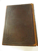 Rear leather board with embossed decorative corner framing and heavy wear along the spine edge.