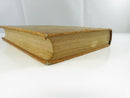 Opposite fore-edge view showing aged page edges, leather corner wear, and board-edge losses.