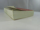 Opposite bottom-edge view of the paperback, showing the bowed and wavy text block.