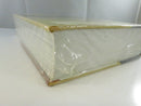 Close view of the bottom fore-edge and lower cover corner under the original shrinkwrap.