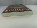 Top-edge view of the paperback showing pronounced page warping from water damage.