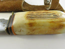 Close view of the bone or faux-stag handle and decorative spacer stack
