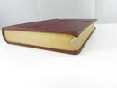Close view of the pasted paper owner label reading “John Harkness.” on the foxed title page.