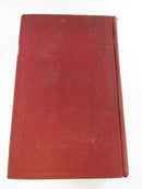 Red cloth cover of one volume with blind-stamped border decoration and rubbed surface wear.