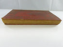 Rear red cloth cover of the hardcover, showing heavy rubbing, soiling, and worn edges.