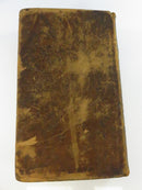Rear board of the original mottled calf binding with extensive scuffing and scratching.