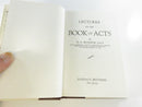 Brown cloth hardcover boards and gilt-lettered spine, with the dust jacket opened beside the book.