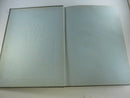 Interior spread with a black-and-white photograph at left and a blue illustrated Howler Wake Forest College divider page at right.