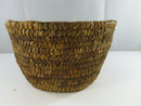 Side view of the basket showing fraying and dry natural fibers around the upper edge.