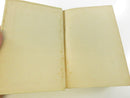 Bottom page edge and worn lower board edge of the hardcover