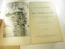 Opened volume displaying marbled endpapers and worn leather joint.