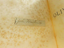 Open text pages from Oliver Twist showing the aged paper and interior typography.