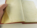 Contents page area with an antique green cloth bookmark laid over the page and printer imprint visible on the facing leaf.