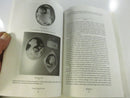 Interior illustrated spread showing cameo photographs and captions, including shell-carved cameos and a bloodstone Medusa cameo.