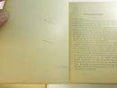 Marbled endpapers and black leather inner hinge of an opened volume.
