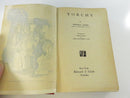 Close view into the open text block, showing age-toned pages and the inner page beginning to detach near the title-page area.
