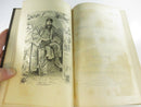 Open pages with a preserved period fern or leaf pressing laid across printed text.