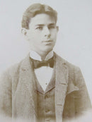 George Seinis (Seinus) Antique Cabinet Card Handsome Young Working Man Bow Tie — front view